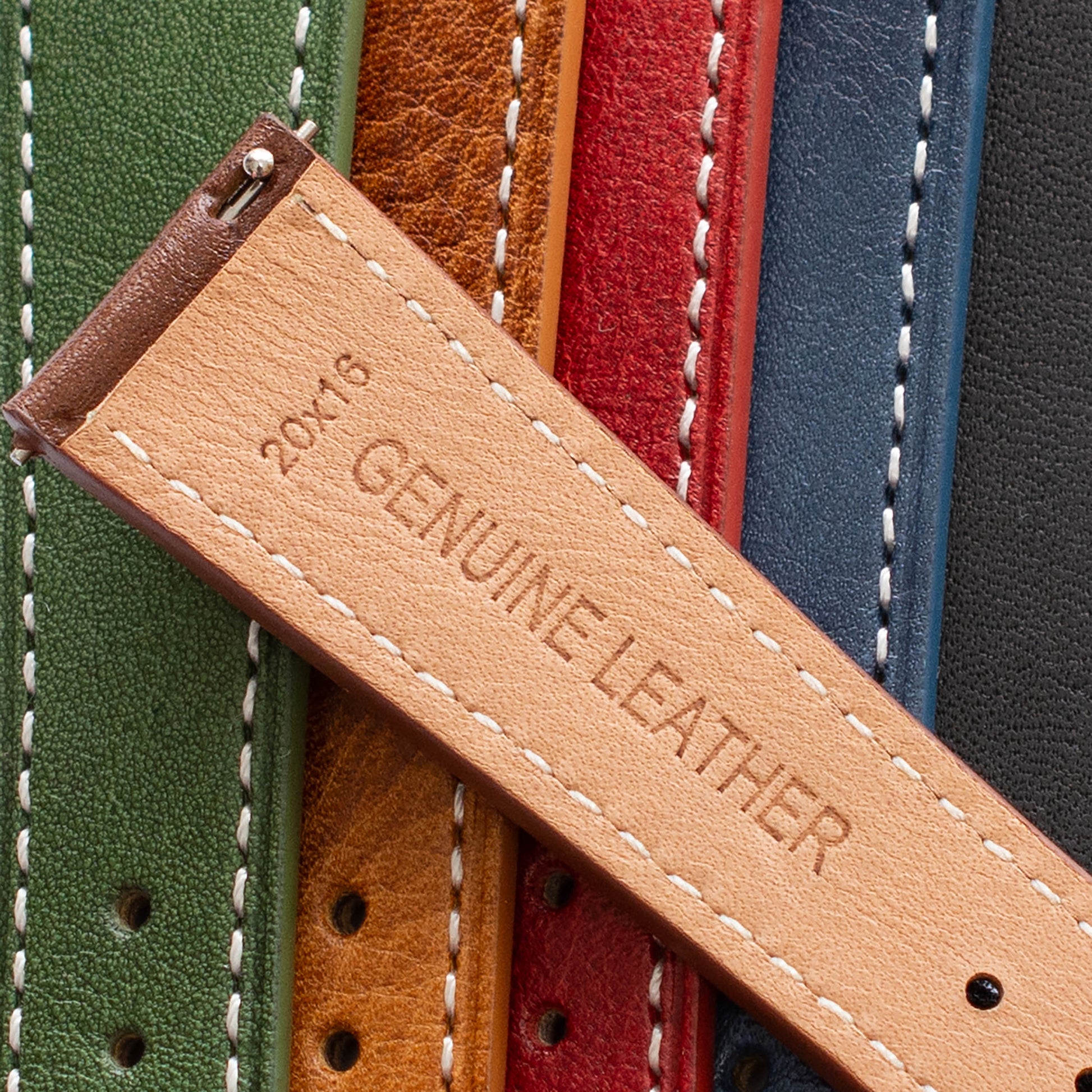 Close-up of various colored leather straps with a 'Genuine Leather' label.