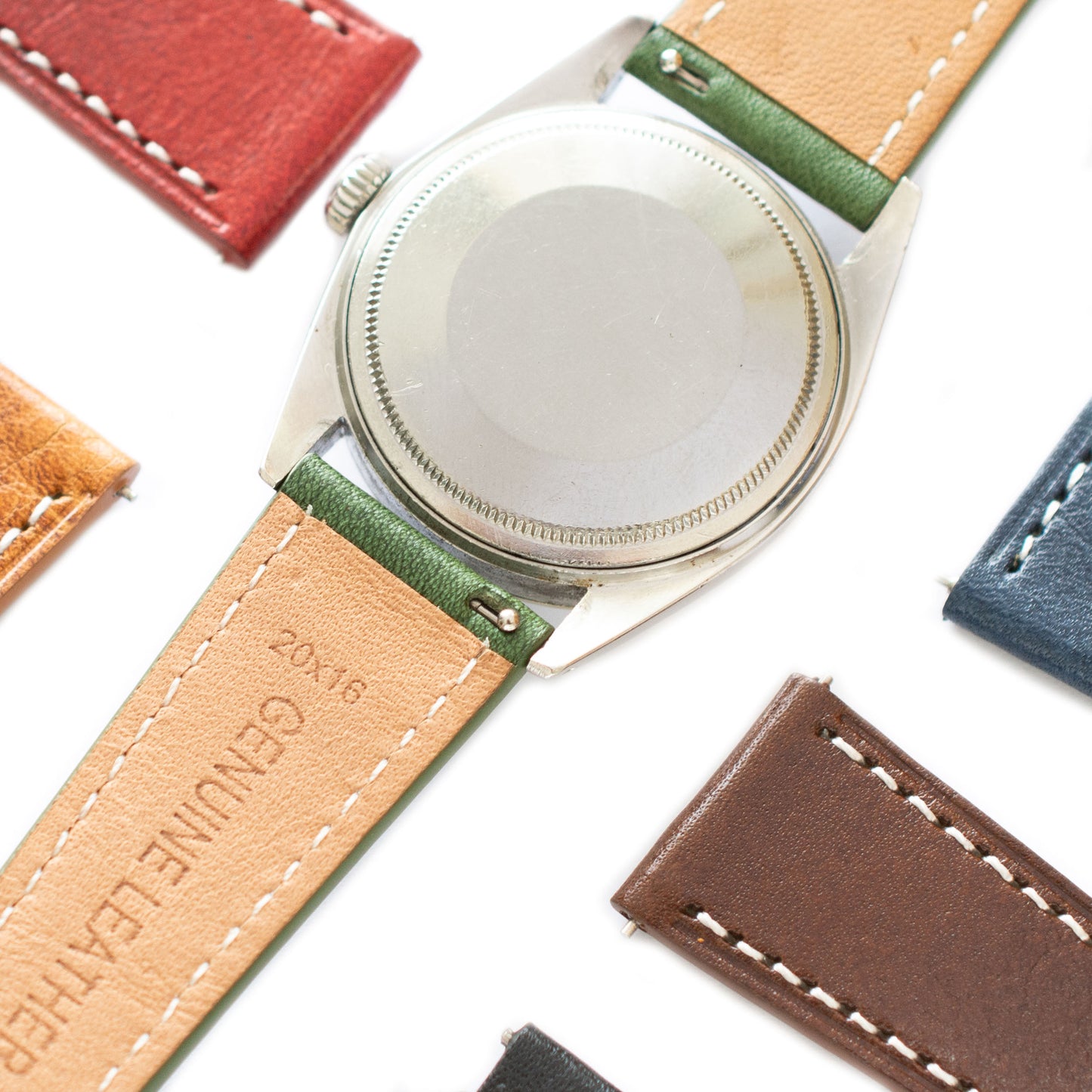 Close-up of a watch with a brown leather strap on a white background